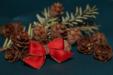 Christmas background - red bow, fir cones and fir twig