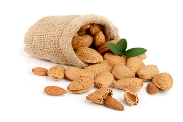 unpeeled almonds with leaf in bag from sacking isolated on white background