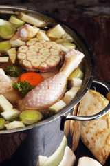 Bone broth made from chicken with carrots, onions various fresh