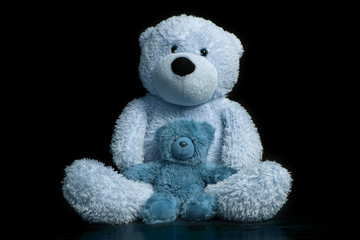 teddy bears big  and small blue on a black background