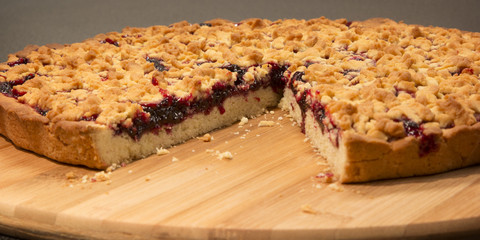 Grated pie with jam and cut a piece