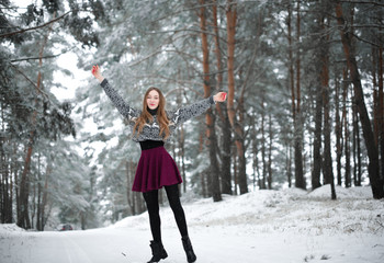 Winter portrait of young beautiful brunette woman wearing sweater. Snowing winter beauty fashion concept.