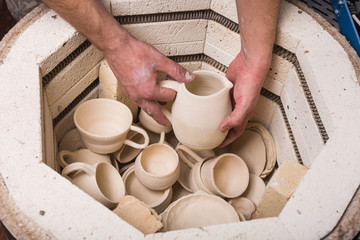 pottery, workshop, ceramics art concept - close-up on electric oven for roasting of unbaked clay...