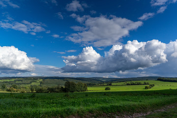 Fototapeta na wymiar Clouds in a blue sky over a beautiful landscape.