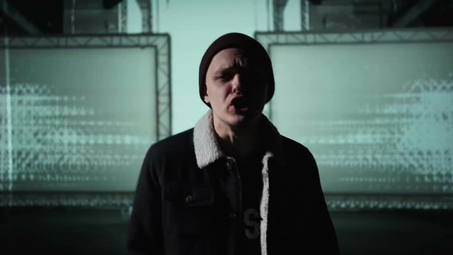 Guy actively reads rap and moves his hands