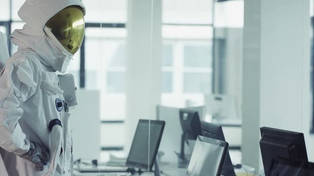  Funny astronaut working in room full of computers & doing a little dance