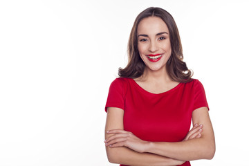 Fototapeta premium Portrait of a Beautiful smiling young brunette girl with clean skin in a red dress isolated on white