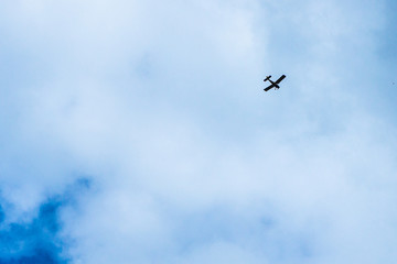 Cloudy sky. The plane flies into the distance.