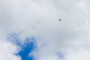 Cloudy sky. The plane flies into the distance.