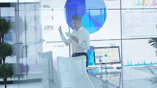 Businessman alone in meeting room rehearsing for business presentation