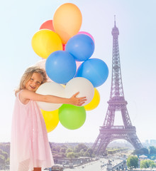 Fototapeta na wymiar Cute little girl having fun playing with balloons