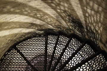 Lighthouse Stairs Background. Light and shadow on the weathered brick walls of the Point Aux...