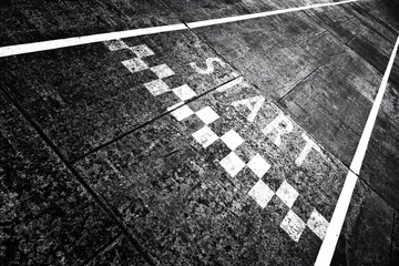 Fototapeten Grunge textured start pattern line sign on the asphalt road. © robsonphoto