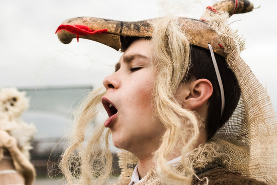 Portrait of young boy in old Slavic dress with traditional mask/Central Serbia