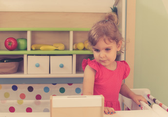 Vintage image of a little girl playing in kindergarten