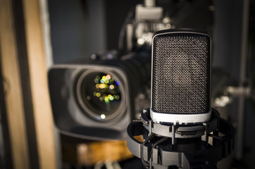 Retro microphone on stage a background of studio camera