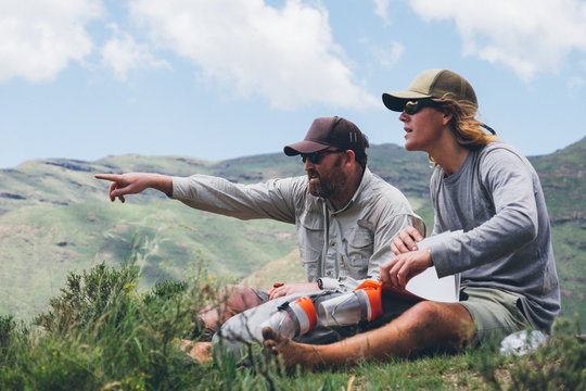 hikers sitting and taking a break whilst out in the mountains