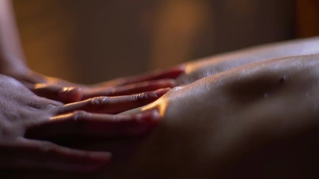 massage of the female back. hands of the masseuse, foot massage