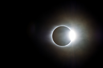 The Sun Emerges From Behind the Moon on a Cloudy Day