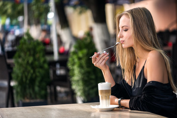girl drinks coffee with spoon