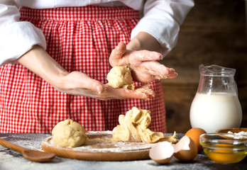 Making dough by female hands at bakery