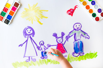 Child's hand paints sketch of the family