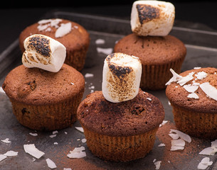 Fresh baked muffins with marshmallows and coconut flakes