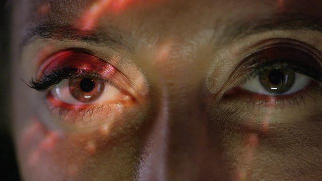  Light projected onto woman's face indicating brain activity or migraine