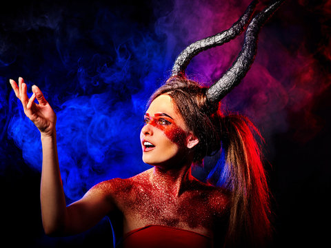 Mad satan woman on black magic ritual of in hell. Witch reincarnation mythical creature on Sabbath. Devil on Halloween. Astral beings are among us. Make-up for night club. Visions of drug addict.