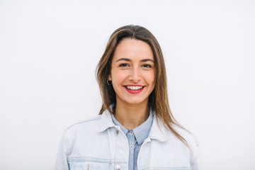 Portrait of a young woman standing over white.