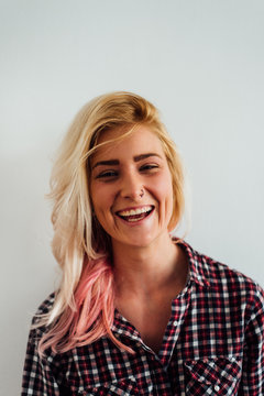 Portrait of a Smiling Blond Woman With Pink Highlight