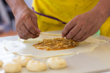 Merchant making delicious roti for customers