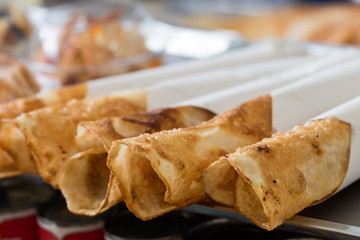 Thai street food of merchant making delicious hot roti for customers