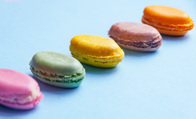 French dessert multicolored macaroni on blue background