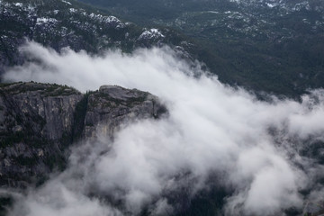 Aerial View of Chief Mountain Covered in Clouds. Taken in Squamish, British Columbia, Canada, during a cloudy winter morning.