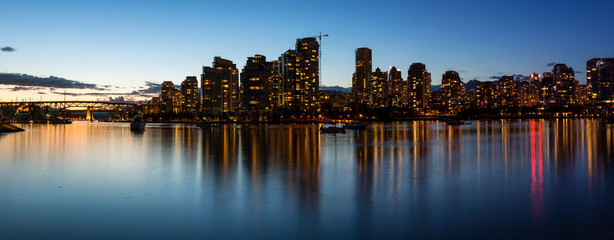 Fototapeta na wymiar Panoramic Skyline of Vancouver Downtown in False Creek, British Columbia, Canada. Taken during a colorful sunset.