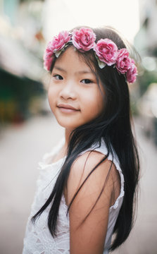 Beautiful little girl portrait with pink rose headband