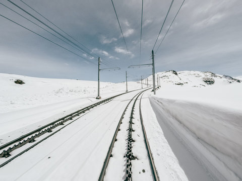 Driver view of train crossing snow mountain