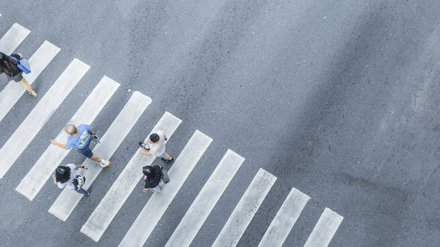 Crowd of people walk on street pedestrian crossroad in the city street ,from top view ,bird eye view.