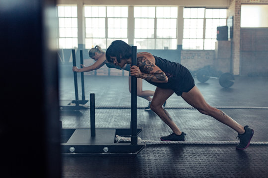 Strong women doing prowler sled workout