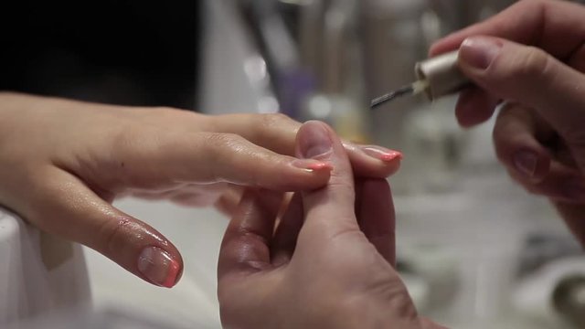 Female hands manicure, nail polish in beauty studio