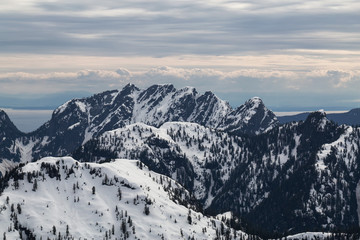 Beautiful aerial landscape view on the snow covered mountains. Taken North of Vancouver, British Columbia, Canada.