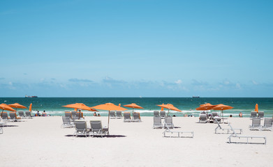 View of orange umbrellas and sun loungers  on the beach