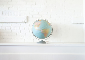 Globe isolated against white wall