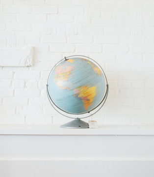 Globe isolated against white wall