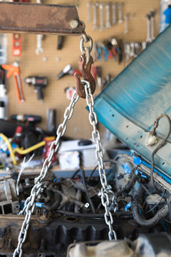 An old engine in a vehicle that is ready to be pulled out