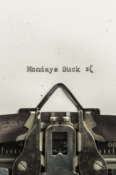 Mondays Suck typed on a vintage typewriter