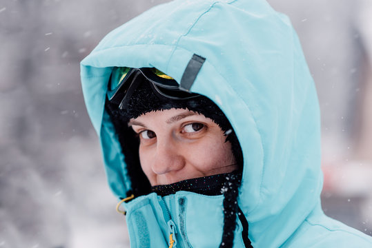 Portrait of a young woman in blue jacket during the winter