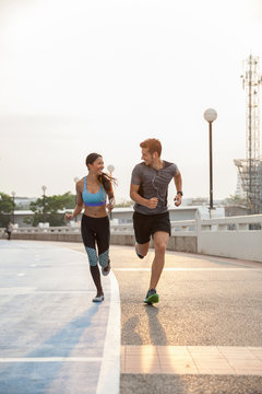 Couple running together outdoors