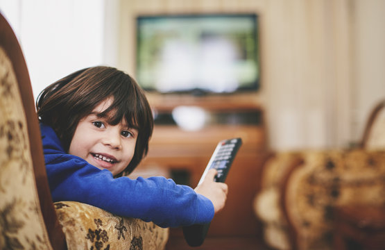 5 years old boy holding a tv remote control